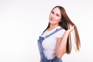 Portrait of a smiling pretty woman in denim overall isolated on white background with copy space