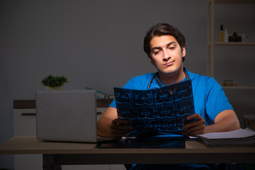 Young handsome doctor working night shift in hospital   