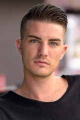 Obraz premium Face of young handsome man outside the coffee shop