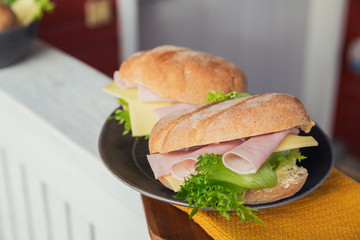 Ciabatta baguette sandwiches with ham, cheese and lettuce