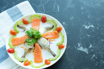 Japanese food mix on a  black stone table.top view composition. Salmon sashimi .