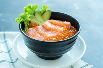 Japanese food mix on a  black stone table.top view composition. Salmon sashimi .