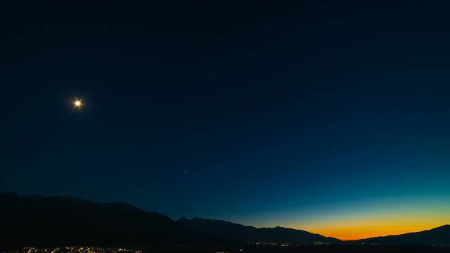 The beautiful moonlight on the mountain background. day to night time lapse