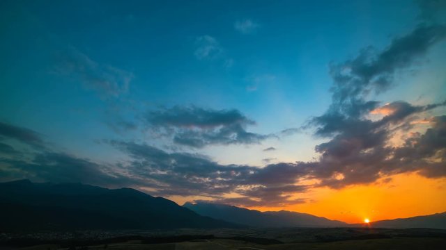 The picturesque sunset above the mountain. day to night time lapse