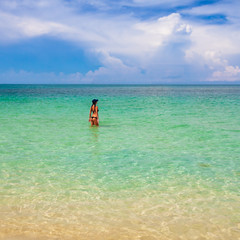 Fototapeta na wymiar Woman in bikini with perfect body standing in sea 