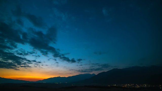 The night to day cycle on the mountain background. time lapse
