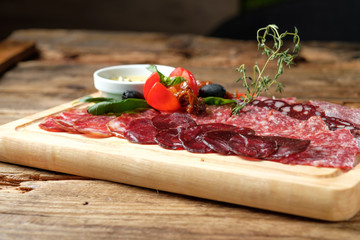 Cutting board with assorted smoked meat