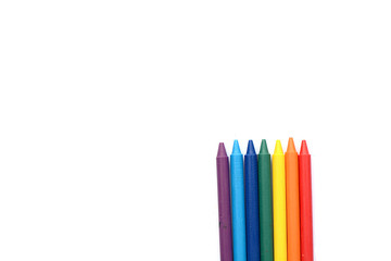 Crayons lined up isolated on white background.