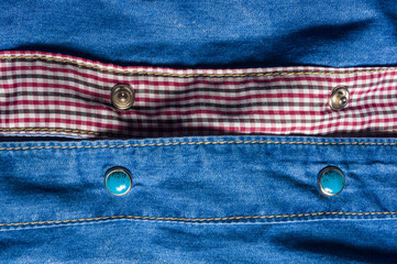 Blue washed faded jeans texture with seams, clasps, buttons and rivets