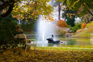 Autumn in central spa park - small lake with statue and fountain in Marianske Lazne (Marienbad) -...