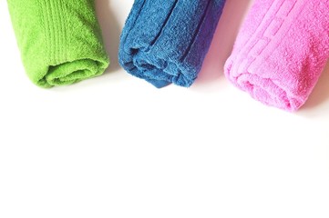 Colorful cotton terry towels on a white background. Flat lay beauty photo for spa and massage salon