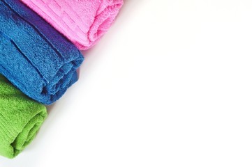 Colorful cotton terry towels on a white background. Flat lay beauty photo for spa and massage salon