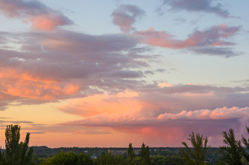 Landscape with dramatic light - beautiful golden sunset with saturated sky and clouds.