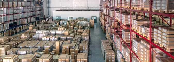 Interior of logistics warehouse with full of pallets and racks
