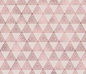 Sparkle geometric seamless pattern with rose gold triangular foil texture. Trendy glitter wallpaper. Modern premium chic background.