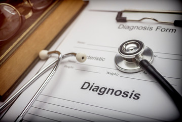 Medical book with a stethoscope and a diagnostic form, conceptual image