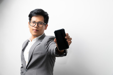 A business man is showing the smartphone with left hand.