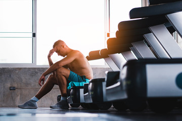 Fototapeta na wymiar Upset man in the fitness after bad running results