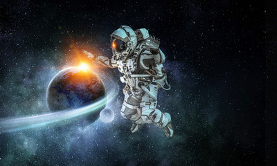 Obraz na płótnie Canvas Astronaut on space mission. Mixed media