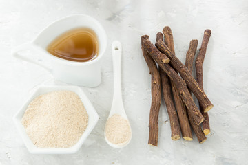 Licorice tea, powder and roots on the table