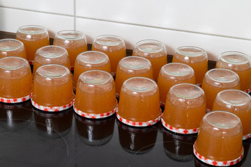 Top view on full jam glasses in the kitchen 