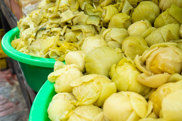 Close up view. Pickled chinese mustard are in bulk for sale in the bazaar.