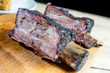 Smoked beef ribs cut on chopping board