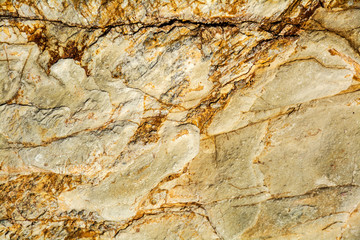 Structure of mountain volcanic rock of dust-colour as a background.
