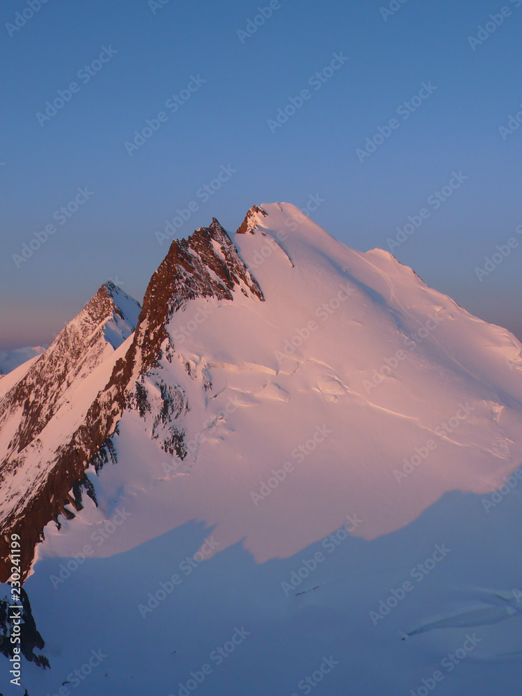 Poster sunrsie and dawn over the mischabel mountains above saas fee in the swiss alps in the valais on a co