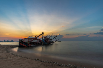 Shipwreck on the beach at sunset