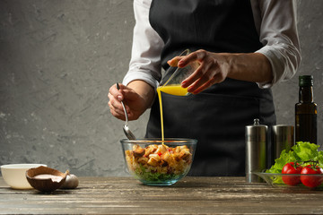 The chef pours sauce over a vegetarian seafood salad. A concrete wall background with a text area for restaurant menu design.