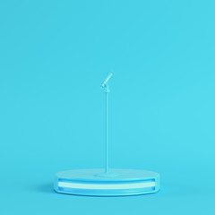 Stage with microphone on bright blue background in pastel colors