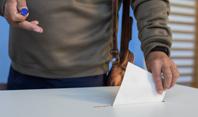 Person voting, casting a ballot
