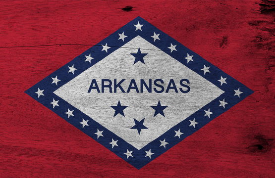 Flag of Arkansas on wooden plate background. Grunge Arkansas flag texture, The states of America.