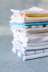 Pile of cotton kitchen napkins on grey background