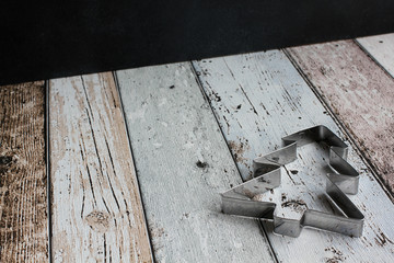 Christmas tree cookie cutter on wooden board, high angle view, copy space