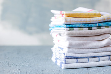 Pile of cotton kitchen napkins on grey background