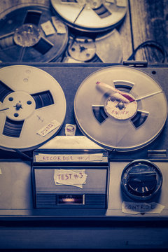 Old audio tape recorder with a few rolls of tape
