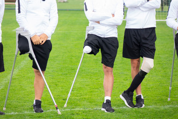 close-up of ampute soccer player and team friends
