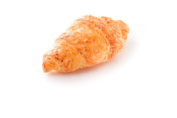 Close-up shot of fresh croissant on white surface isolated.