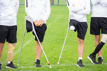 close-up of ampute soccer player and team friends
