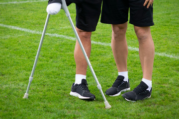 close-up of ampute soccer player and team friend