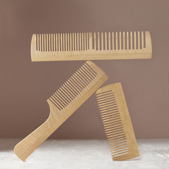Wooden hair or beard combs on brown background