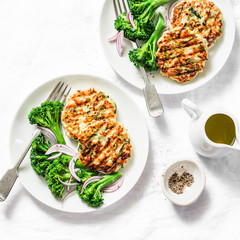 Chicken zucchini burgers with boiled broccoli - delicious healthy diet lunch on a light background, top view