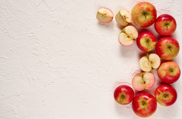 Various fresh red apples on the white concrete background. Top view with copy space for text