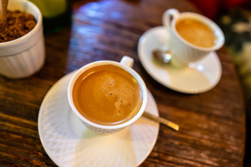 Hot Esspresso coffee on wooden table from Top view