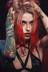 Tattooed skinny girl almost naked for adds with some intentional noise and soft focus