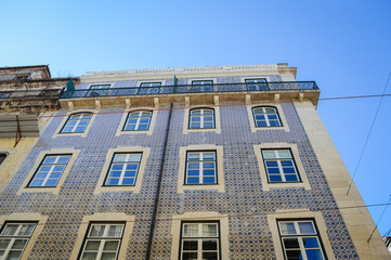 Typical portuguese streets, apartment windows and houses on traditional district scene in Lisbon, Portugal. historical structure view.