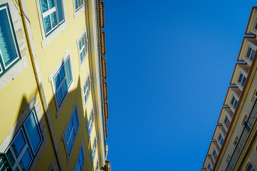Typical portuguese streets, apartment windows and houses on traditional district scene in Lisbon, Portugal. historical structure view.