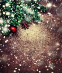 Christmas wooden background with fir tree, decoration and snow. Copy space. Flat lay..